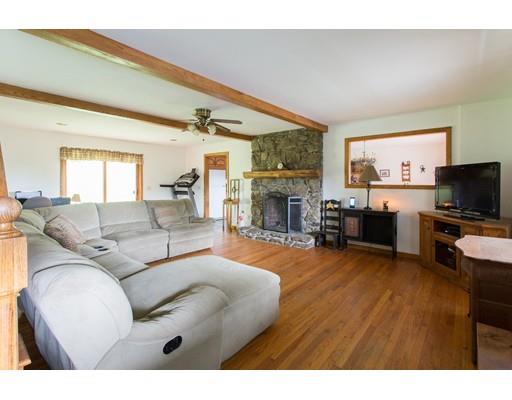 197 Douglas Road Warren, MA 01083 - Photo 9 of 28 a living room with furniture a fireplace and a flat screen tv