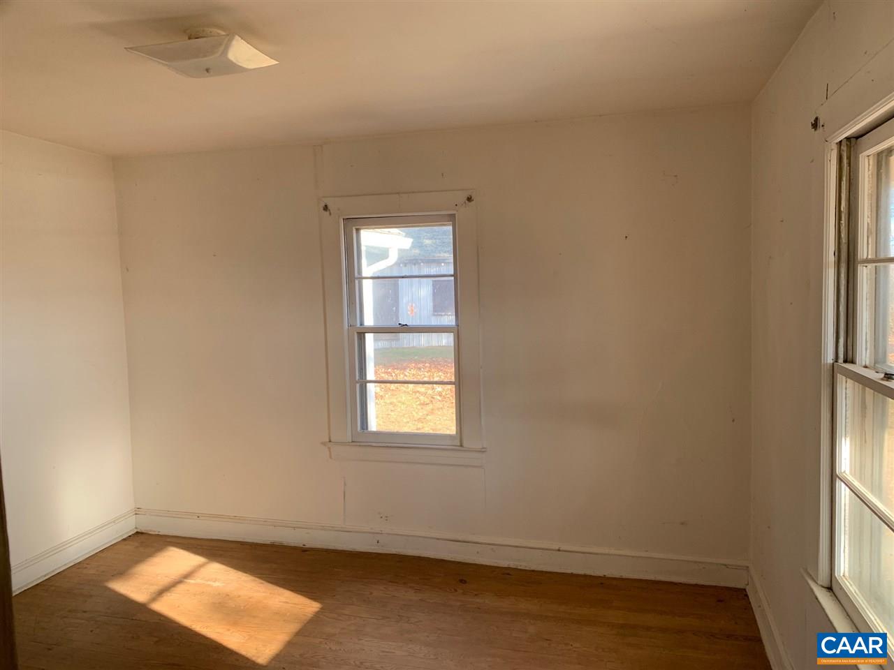 2615 Dunnes Shop Road Ruckersville, VA 22968 - Photo 7 of 22 an empty room with wooden floor and windows