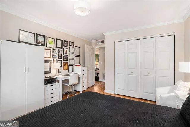 a view of a kitchen with fridge and wooden floor