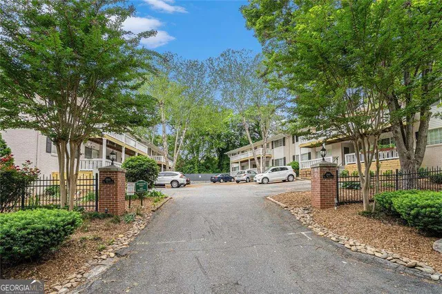 a row of palm trees in front of a building