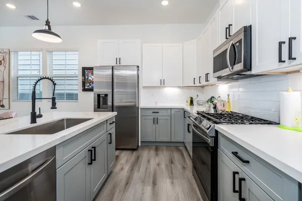 a kitchen with a dining table and chairs