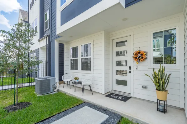 a view of a chair and table in the back yard of the house