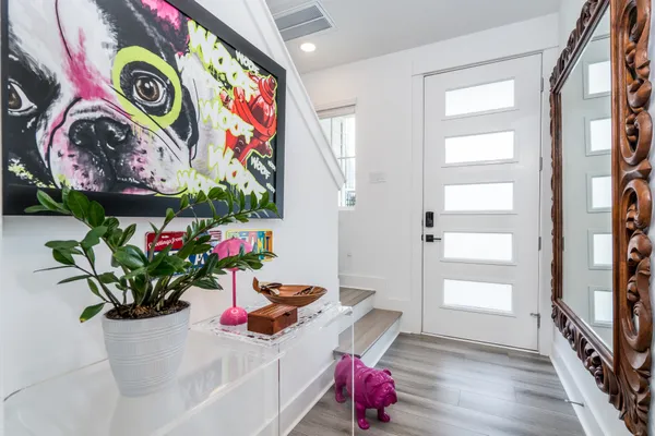 a hallway with a potted plant on the wall