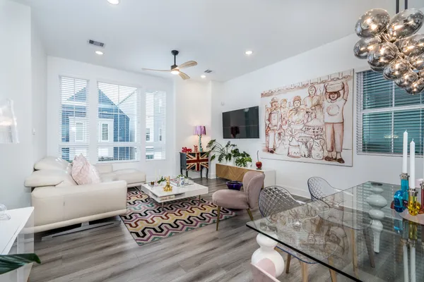 a kitchen with stainless steel appliances kitchen island granite countertop a table chairs and a refrigerator