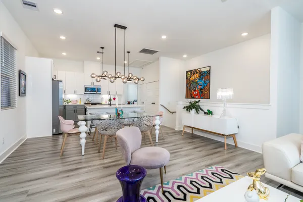 a living room with furniture and wooden floor