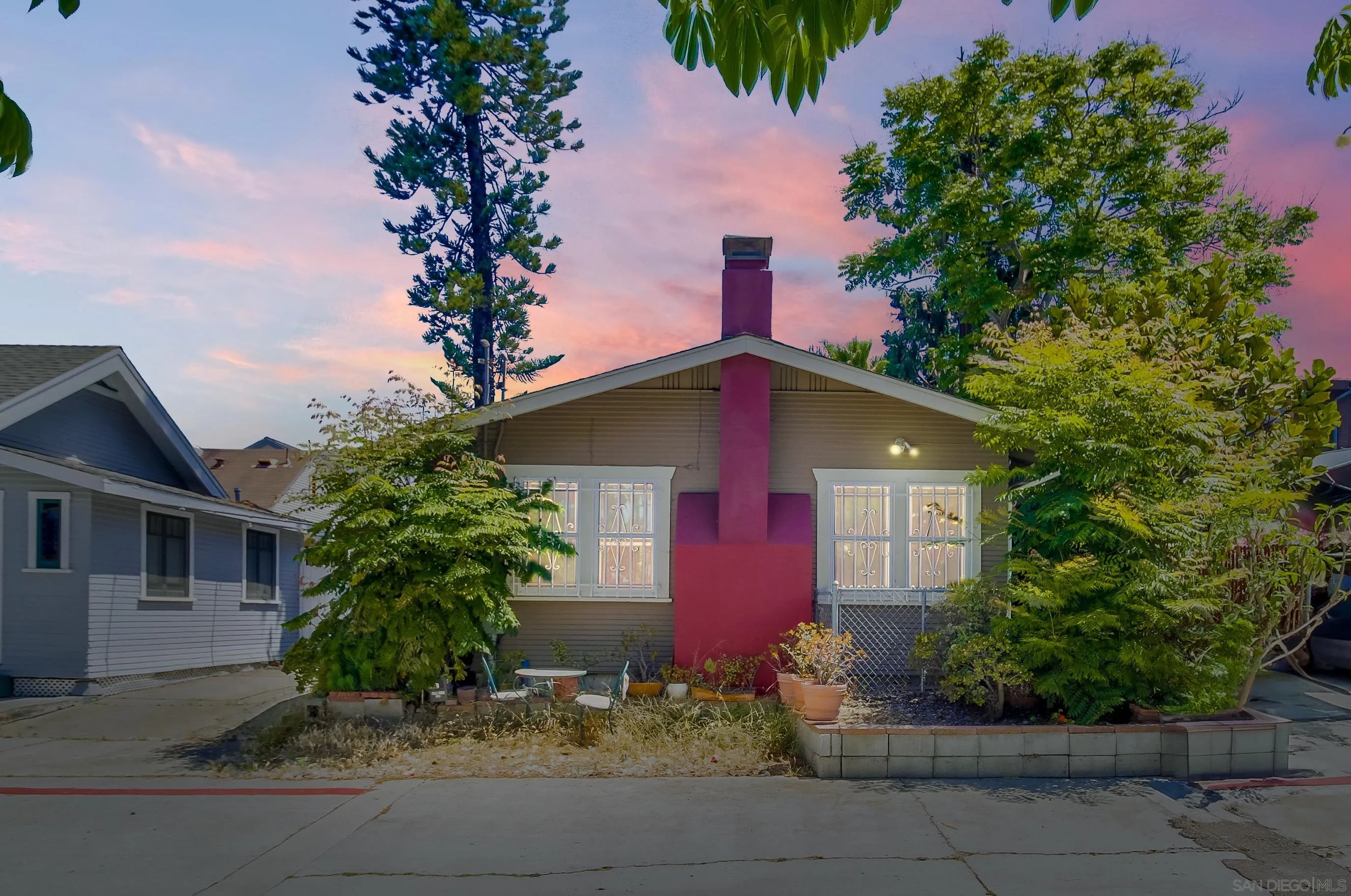 a front view of a house with plants