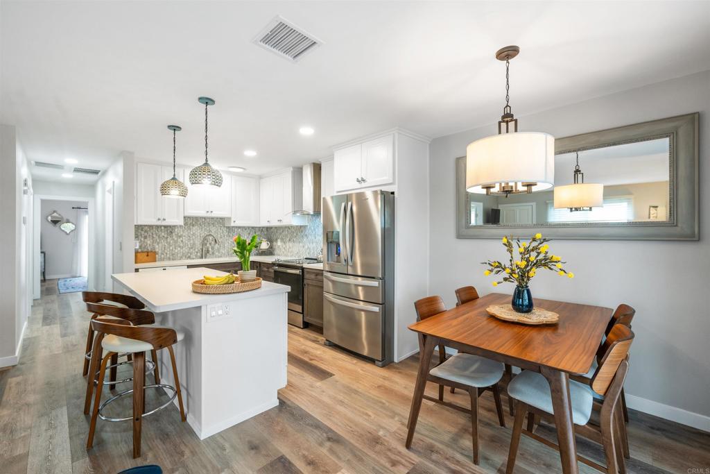 315 Volney Lane Encinitas, CA 92024 - Photo 18 of 51 a kitchen with a dining table chairs stainless steel appliances and cabinets