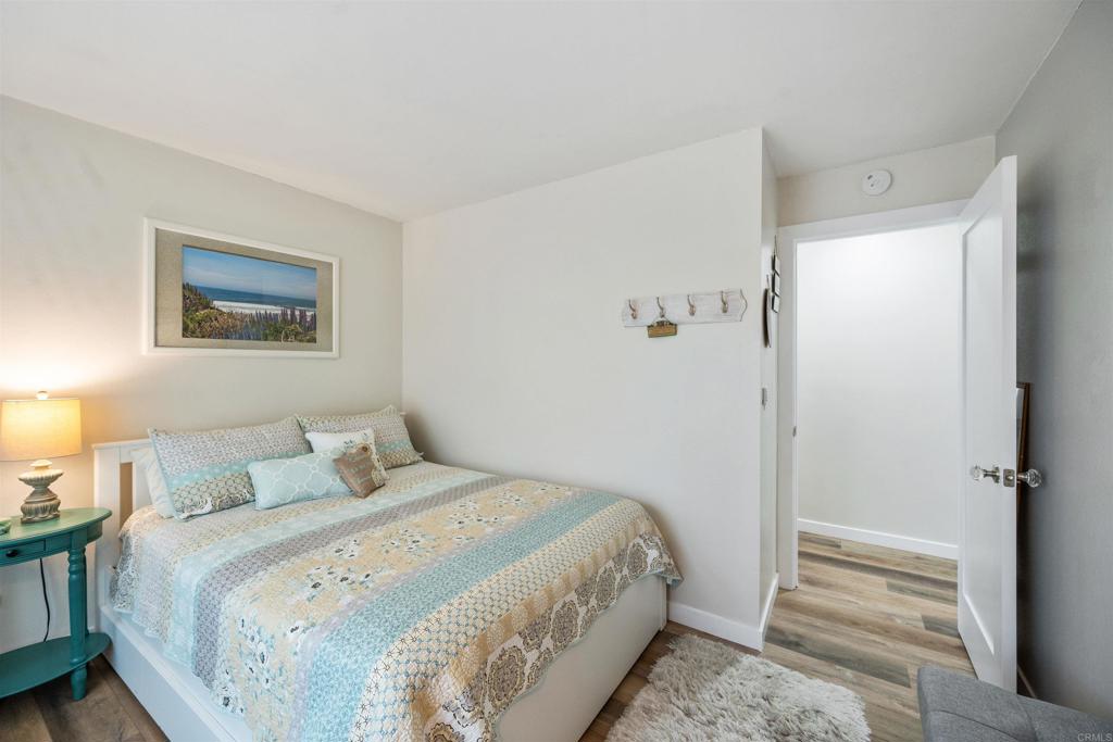315 Volney Lane Encinitas, CA 92024 - Photo 27 of 51 a bedroom with a bed and a painting on the wall