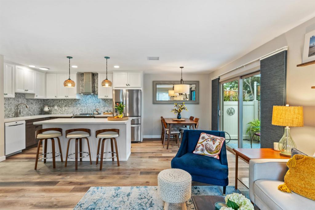 315 Volney Lane Encinitas, CA 92024 - Photo 8 of 51 a living room with stainless steel appliances granite countertop furniture a fireplace a rug kitchen view and a large window