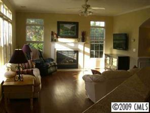 15819 Lavenham Road Huntersville, NC 28078 - Photo 6 of 8 a living room with furniture a flat screen tv and a fireplace