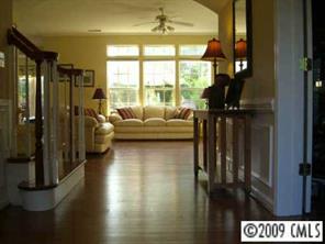 15819 Lavenham Road Huntersville, NC 28078 - Photo 7 of 8 a living room with furniture and a floor to ceiling window