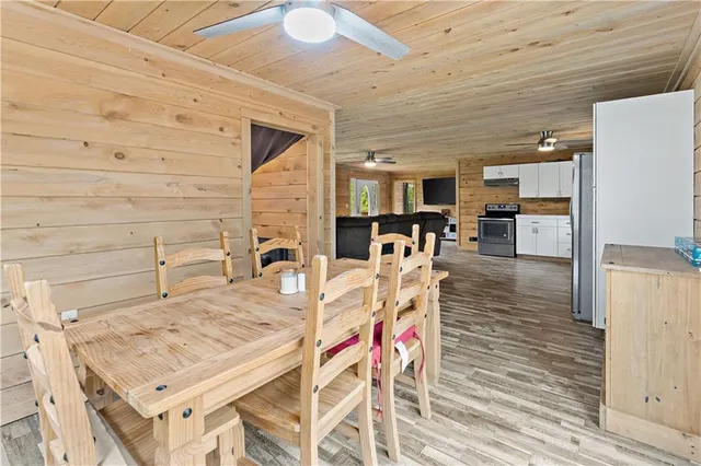 a living room with furniture and kitchen view