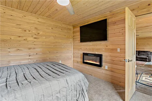 a bedroom with a bed and a flat screen tv