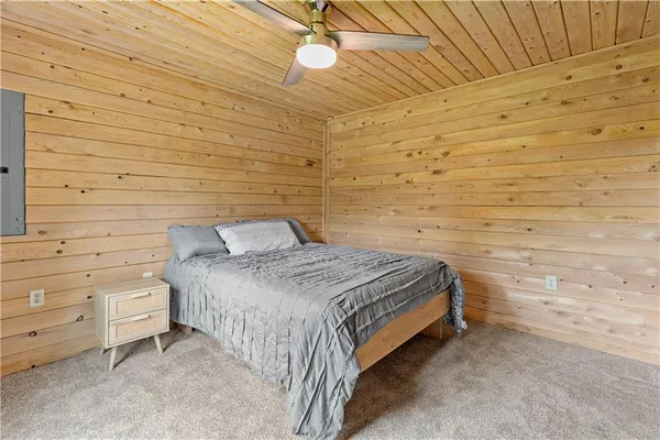 a bedroom with a bed and a ceiling fan