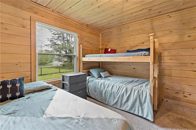 a bedroom with two beds and a window