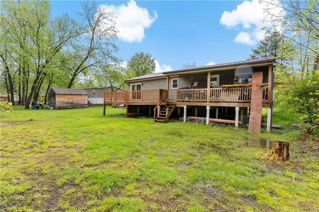 a view of balcony with wooden floor and fence