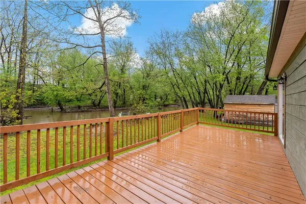 a view of a wooden deck and trees