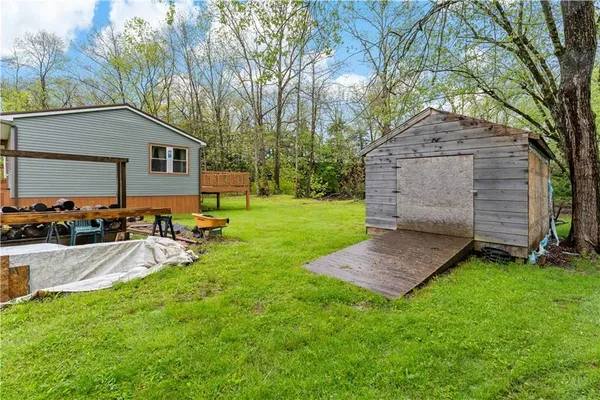 a view of a house with a yard and sitting area