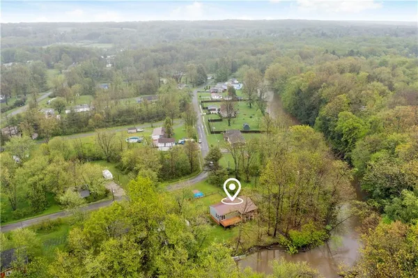 an aerial view of a house with a yard basket ball court