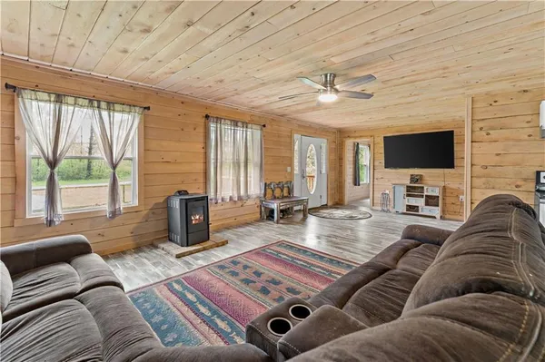 a living room with furniture large window and a flat screen tv