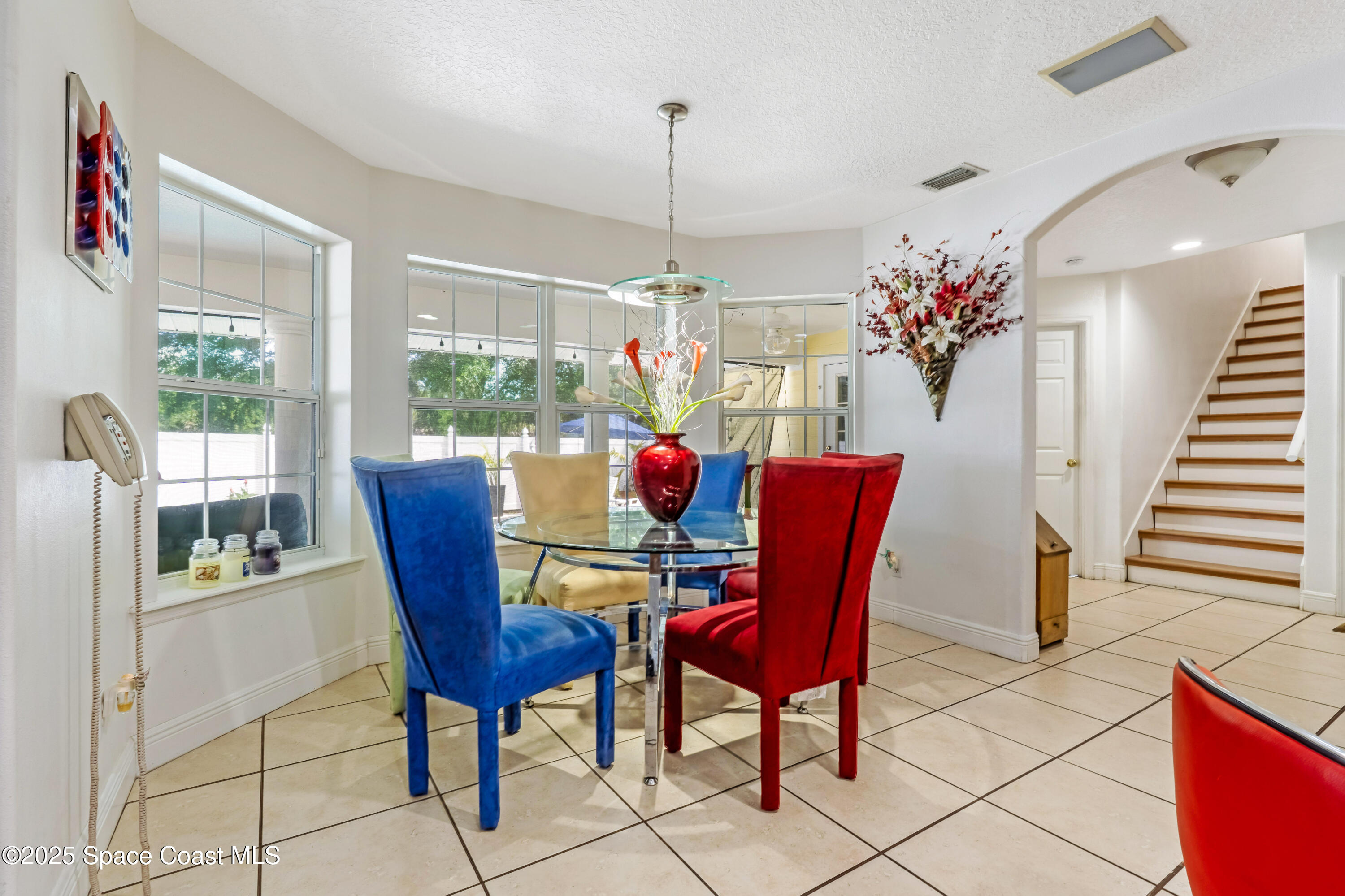 4985 Hamlin Circle Mims, FL 32754 - Photo 12 of 39 a dining room with furniture a chandelier and window