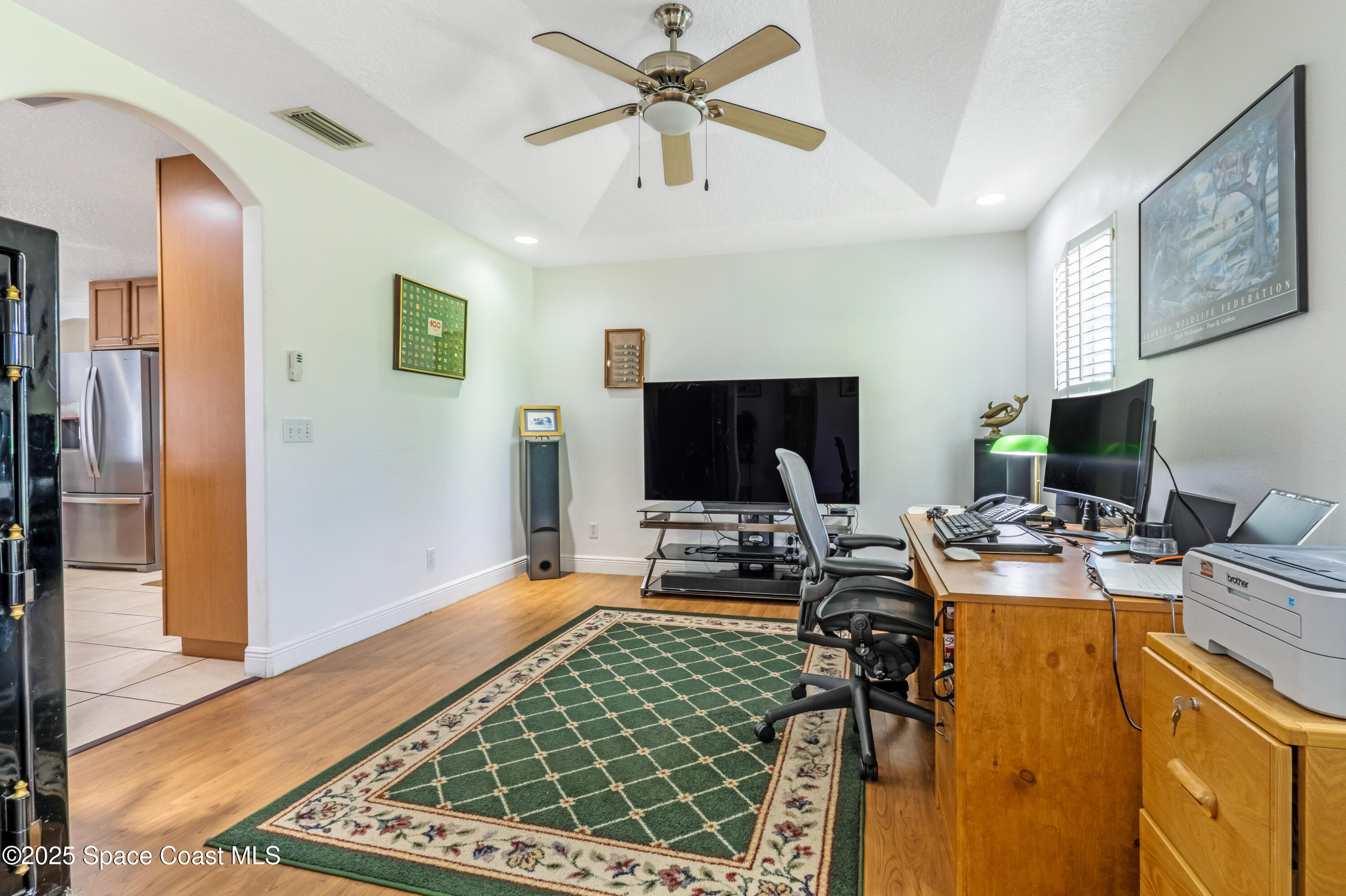4985 Hamlin Circle Mims, FL 32754 - Photo 14 of 39 a view of a workspace with furniture and a flat screen tv