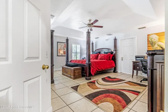 a bedroom with two beds and a chandelier