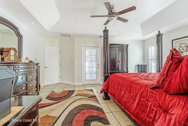 a bedroom with bed and a chandelier