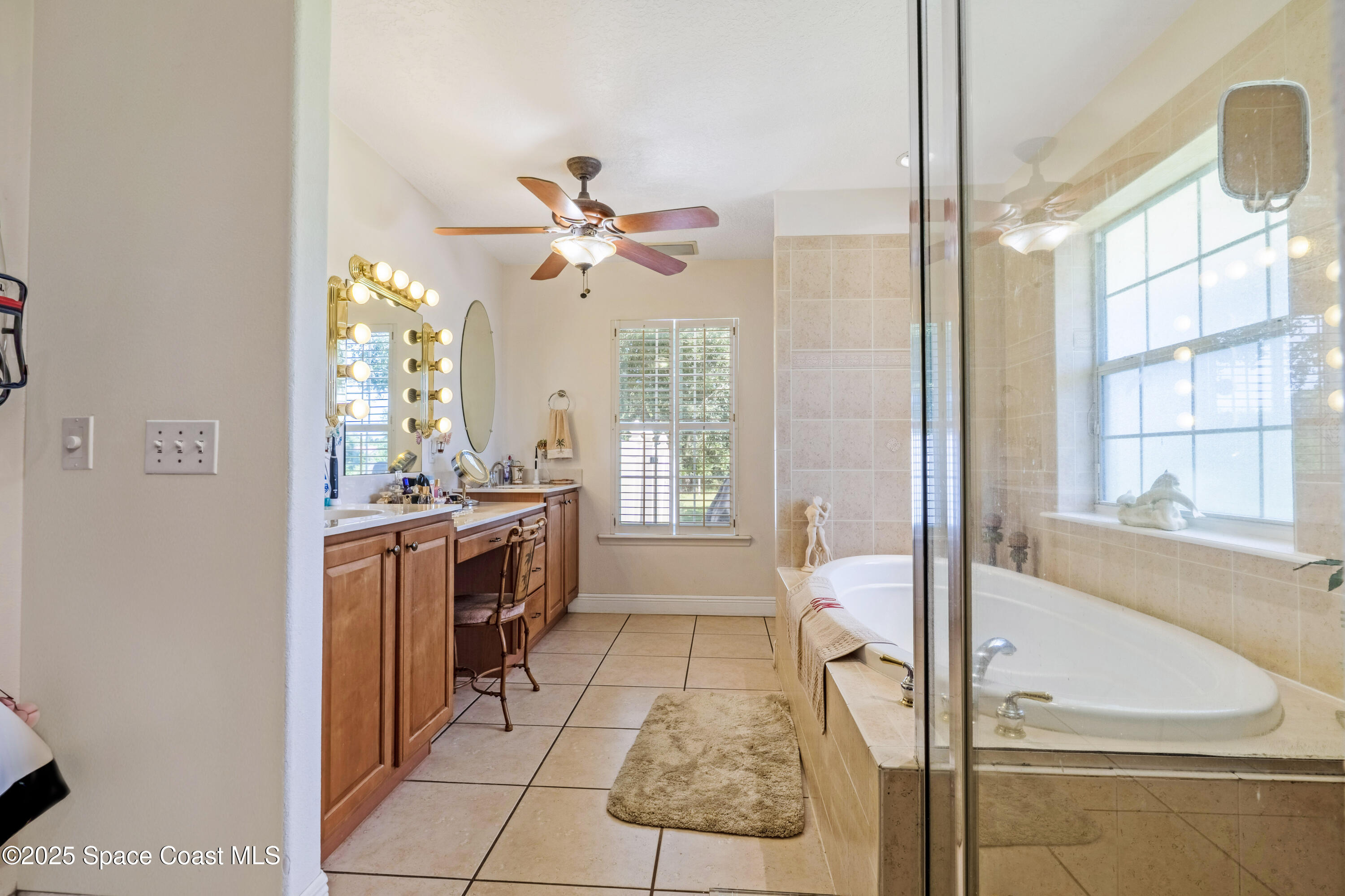 4985 Hamlin Circle Mims, FL 32754 - Photo 19 of 39 a spacious bathroom with a tub a sink and a large mirror