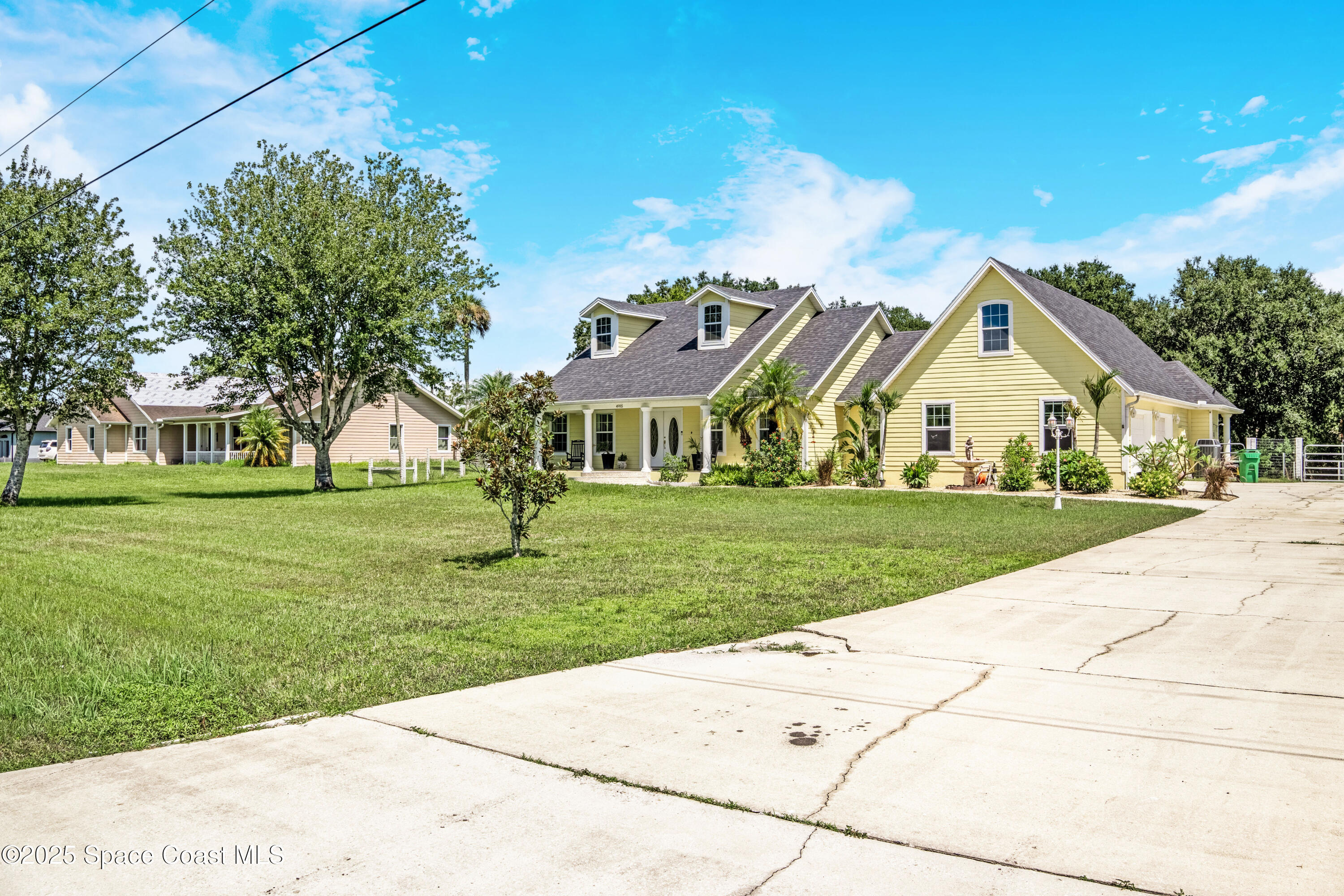 4985 Hamlin Circle Mims, FL 32754 - Photo 2 of 39 a view of house with yard and green space