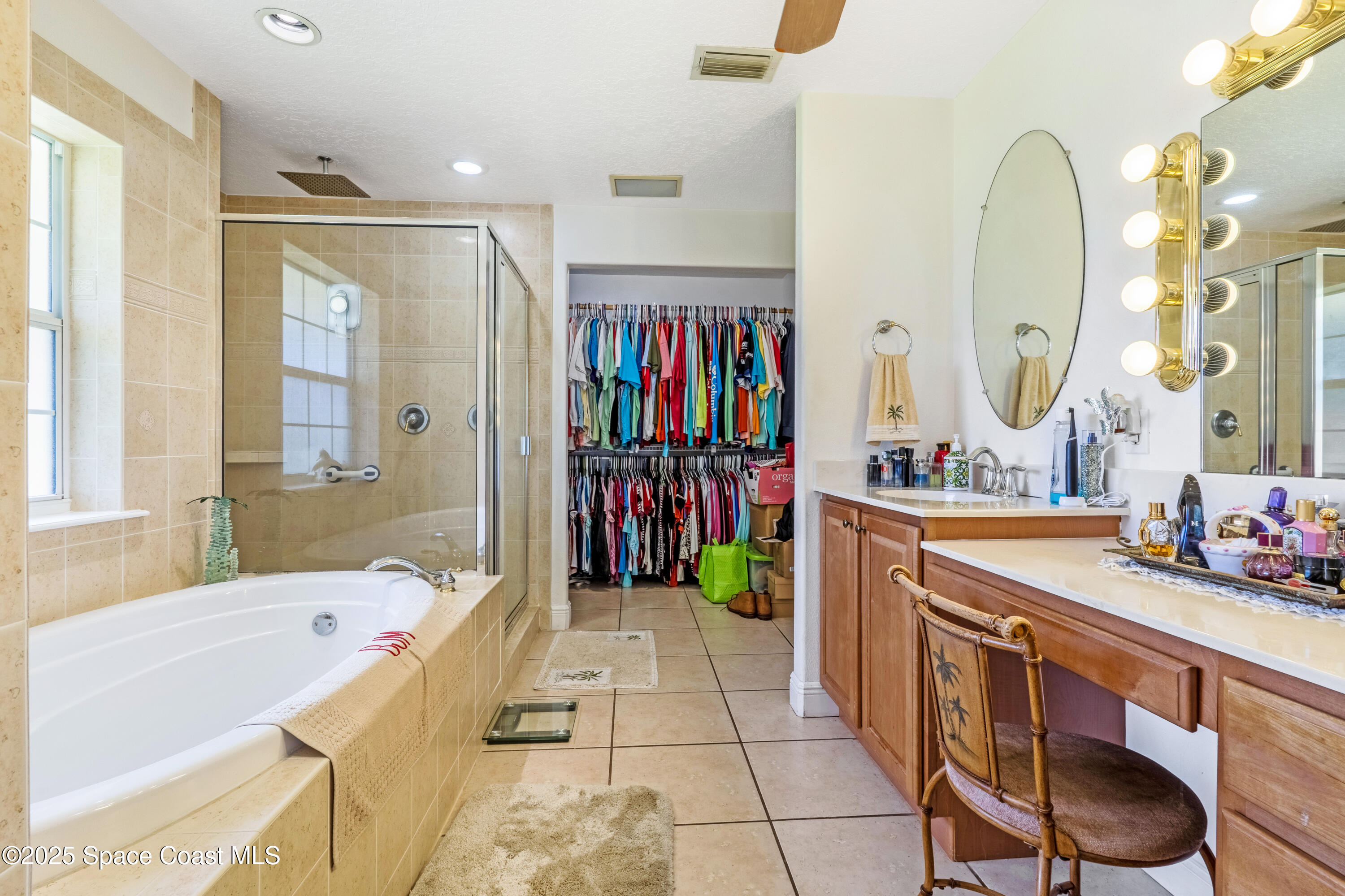 4985 Hamlin Circle Mims, FL 32754 - Photo 21 of 39 a spacious bathroom with a double vanity sink a mirror a bathtub and next to a window