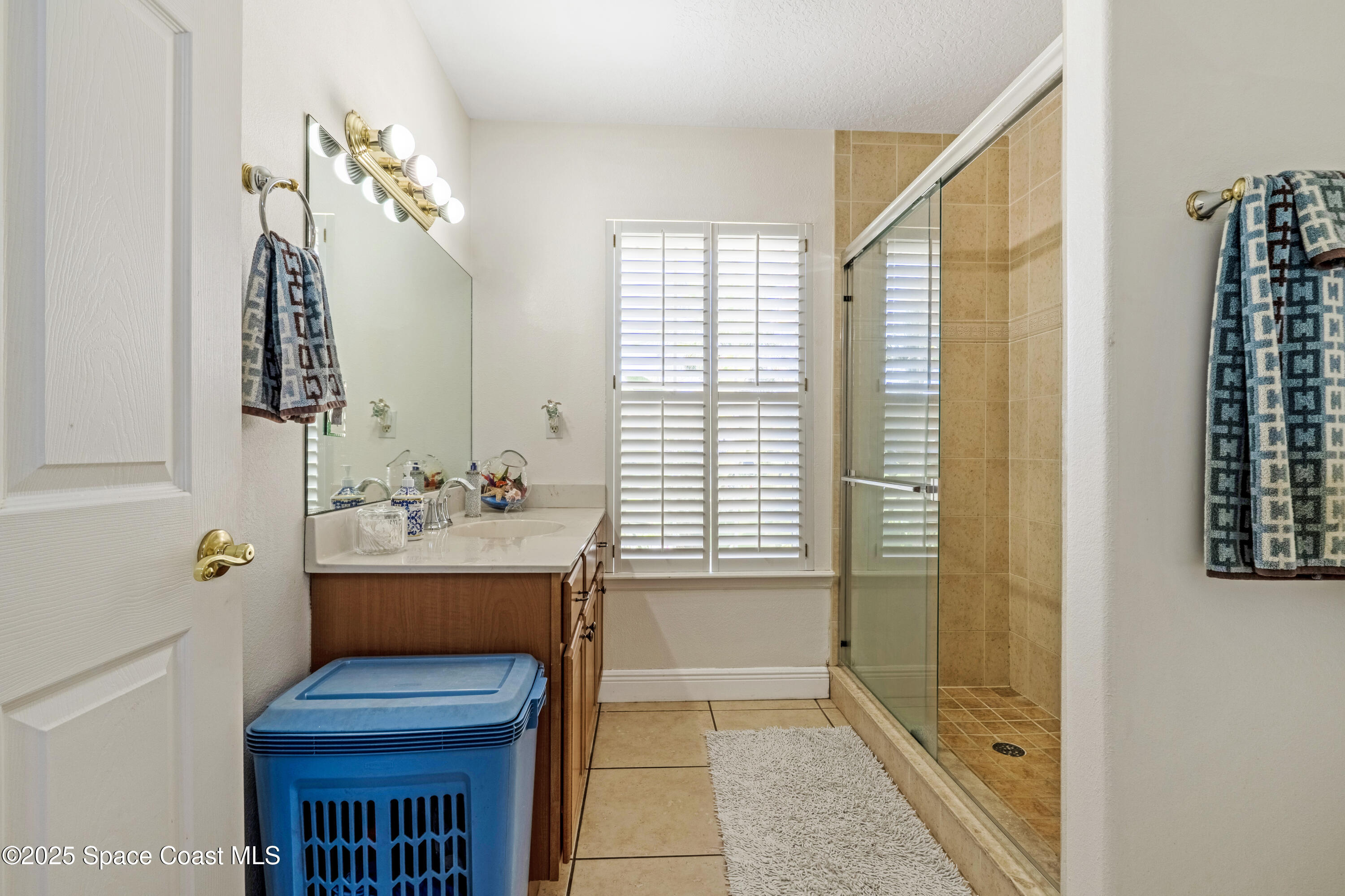 4985 Hamlin Circle Mims, FL 32754 - Photo 22 of 39 a bathroom with a sink a toilet and shower