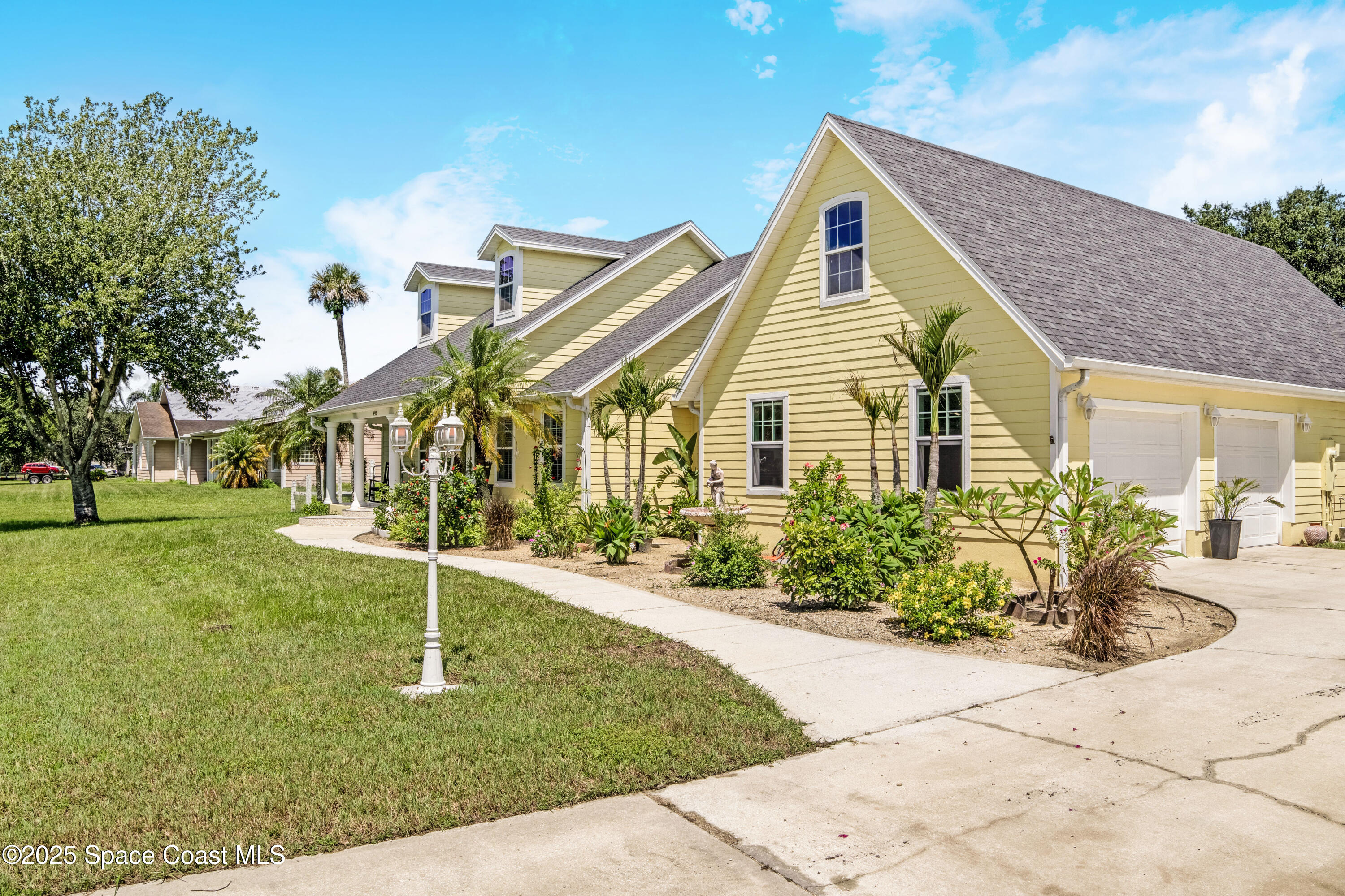 4985 Hamlin Circle Mims, FL 32754 - Photo 3 of 39 a front view of a house with garden