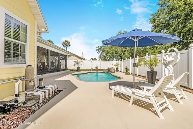 a view of green field with trees in the background