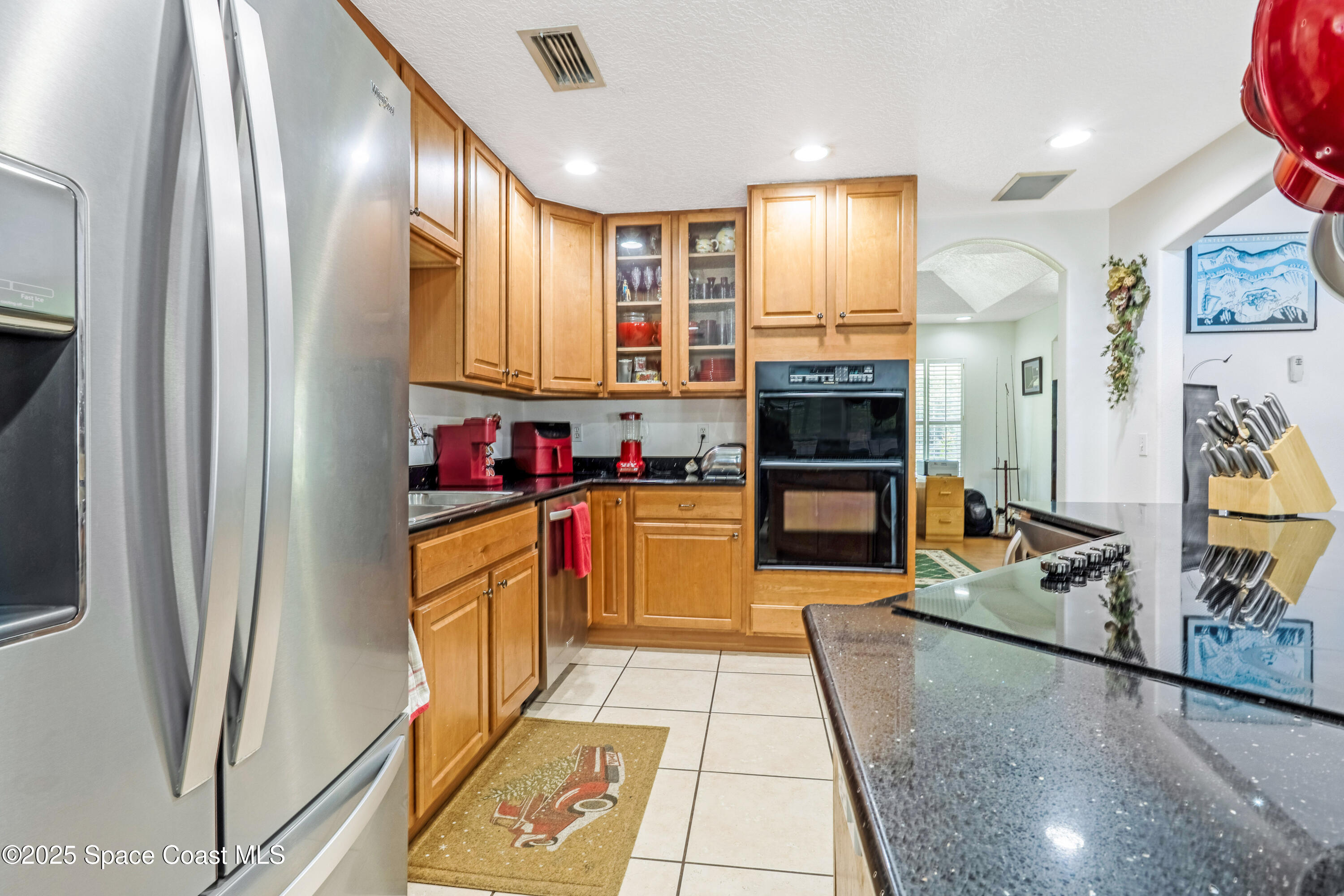 4985 Hamlin Circle Mims, FL 32754 - Photo 10 of 39 a kitchen with stainless steel appliances granite countertop a refrigerator and a stove