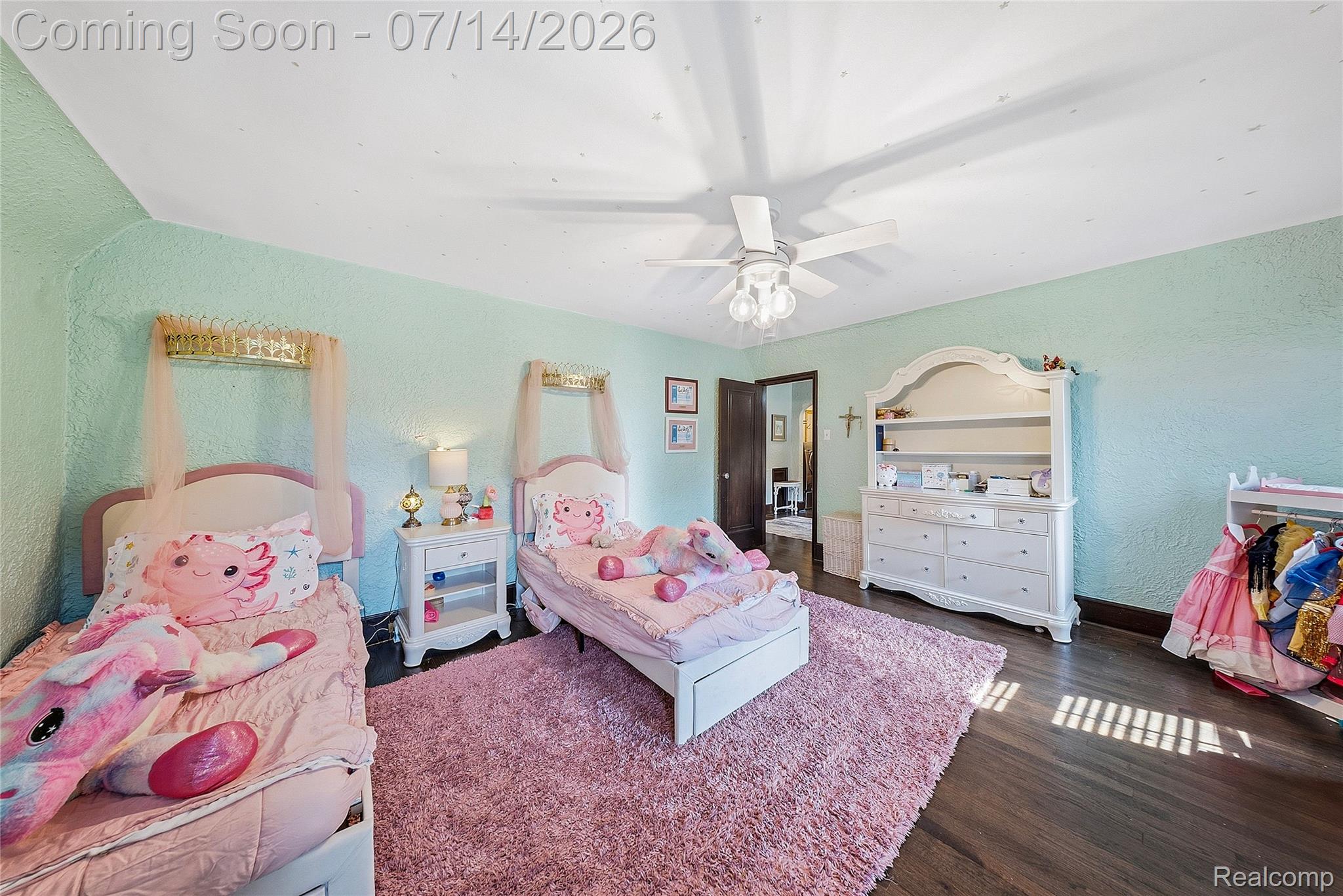 18460 Meridian Road Grosse Ile, MI 48138 - Photo 28 of 50 Spacious room featuring rich wood-finish flooring, light blue textured walls, and a ceiling fan with integrated lighting