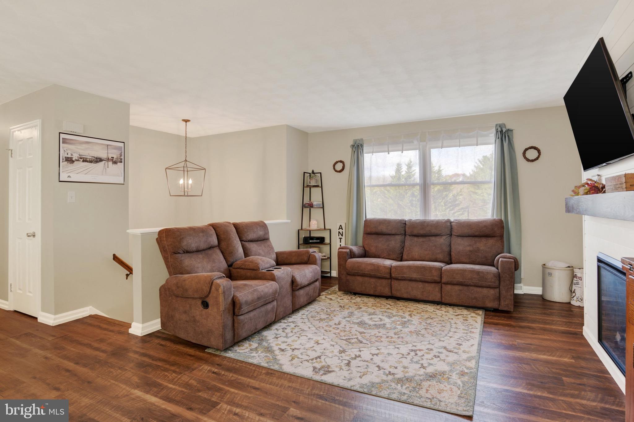 329 South Crawford Road Hummelstown, PA 17036 - Photo 2 of 17 a living room with furniture and a flat screen tv