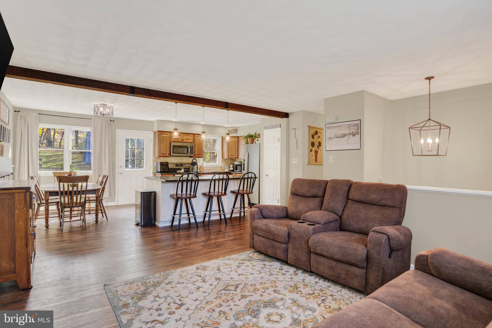329 South Crawford Road Hummelstown, PA 17036 - Photo 4 of 17 a living room with furniture and a dining table with wooden floor