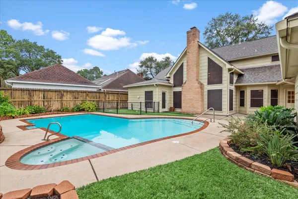 a view of an house with swimming pool and yard