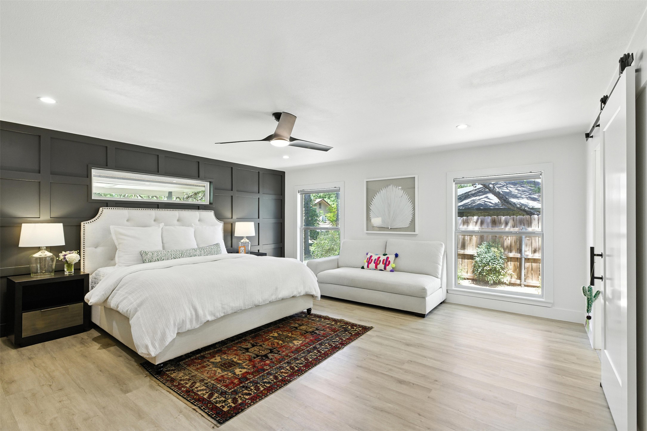 2403 Gateshead Circle Austin, TX 78745 - Photo 11 of 22 Naturally illuminated bedroom with contemporary paneling and wood-like flooring.