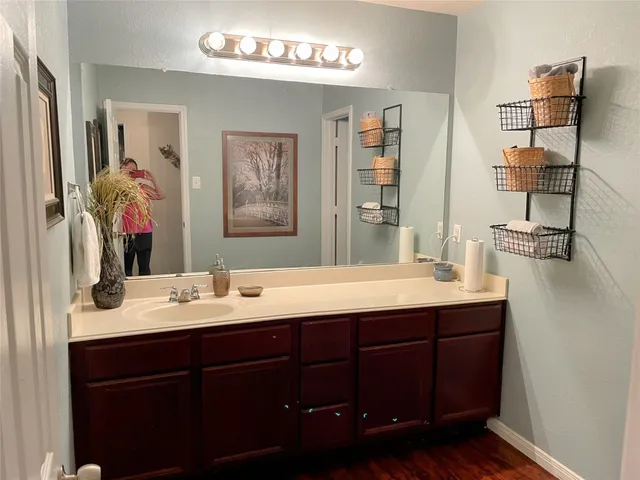 a bathroom with a double vanity sink and a mirror