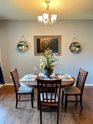 a dining room with furniture and wooden floor