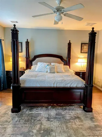 a bed sitting in a bedroom next to a window