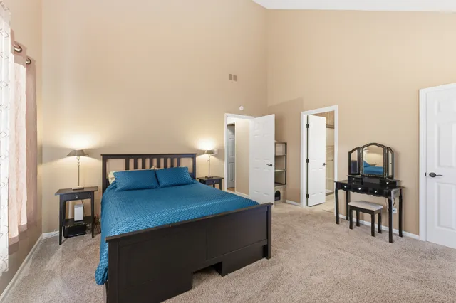 a bedroom with a bed and a chair