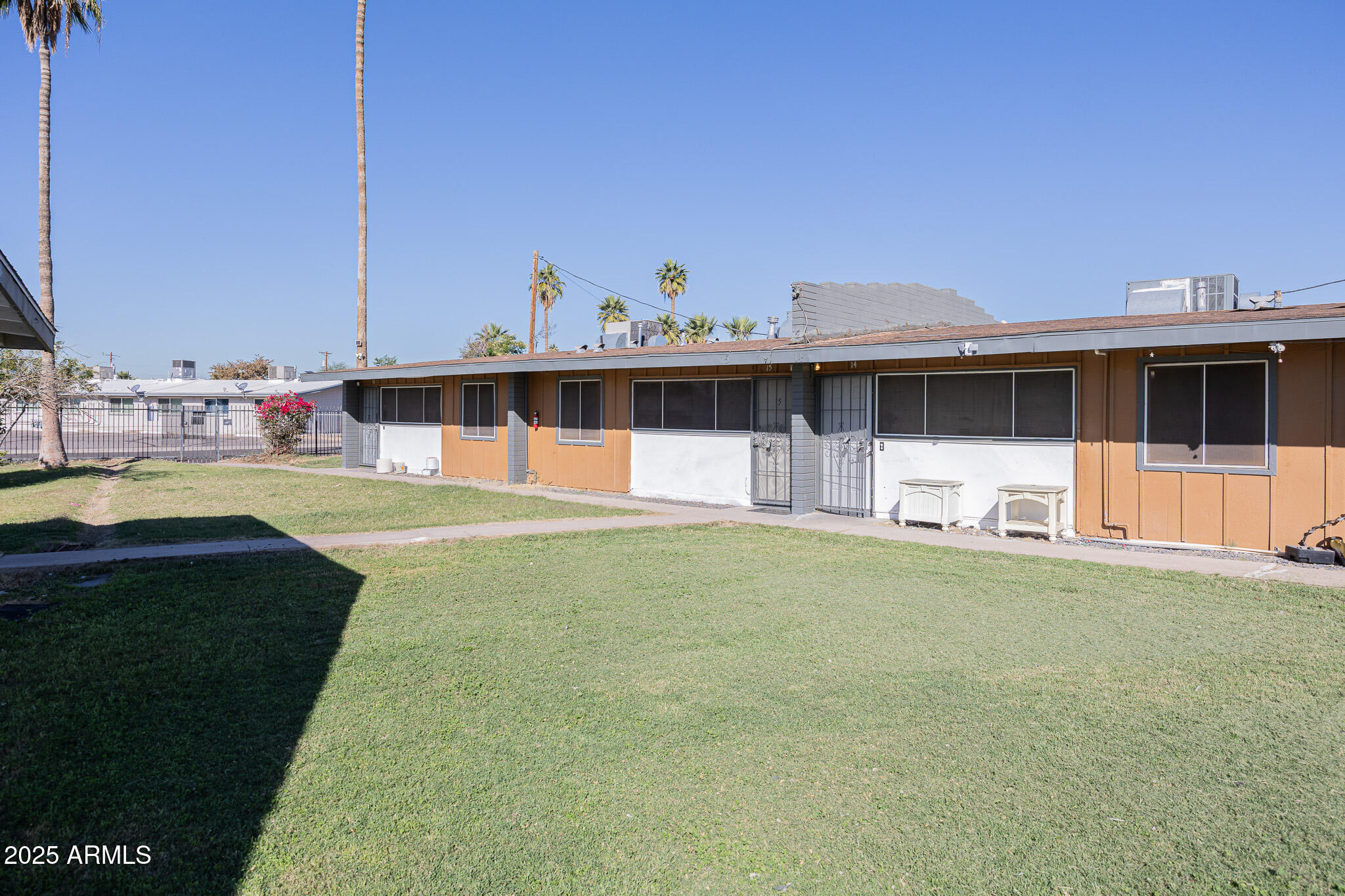 2123 West Devonshire Avenue, Unit 14 Phoenix, AZ 85015 - Photo 1 of 13 a backyard of a house with table and chairs