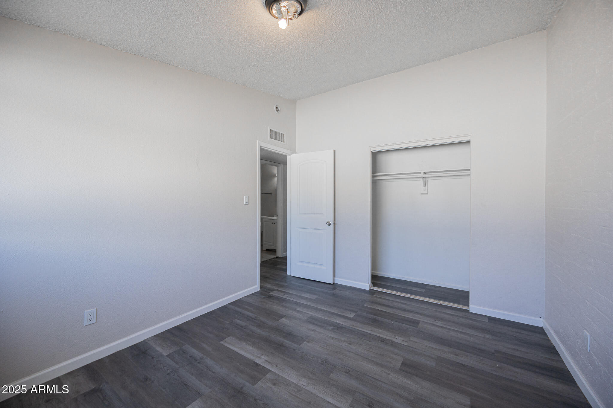 2123 West Devonshire Avenue, Unit 14 Phoenix, AZ 85015 - Photo 13 of 13 a view of an empty room with wooden floor