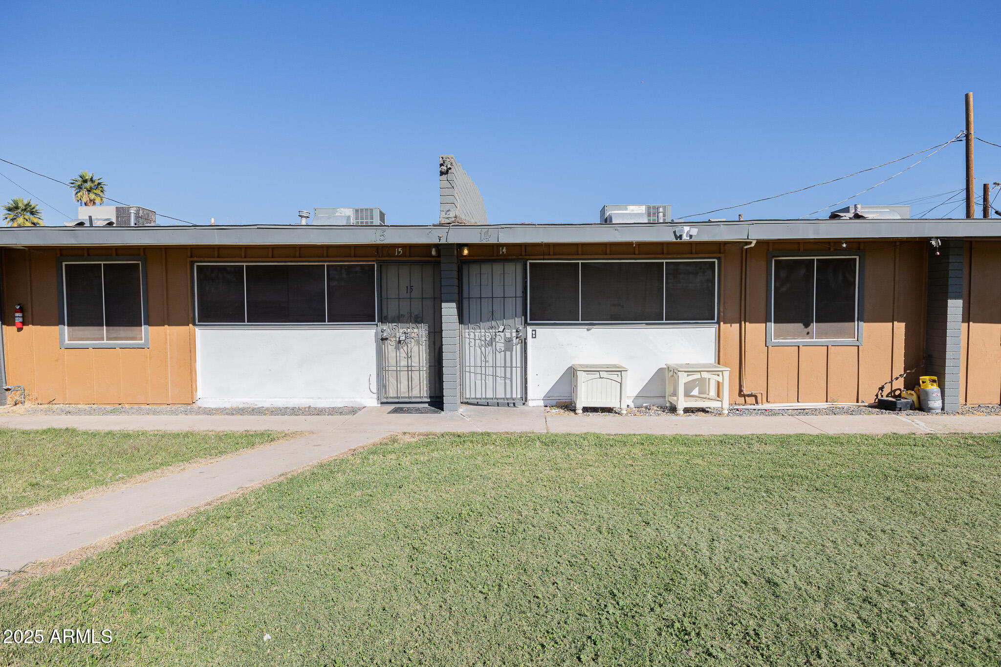 2123 West Devonshire Avenue, Unit 14 Phoenix, AZ 85015 - Photo 2 of 13 a front view of a house with a yard and garage