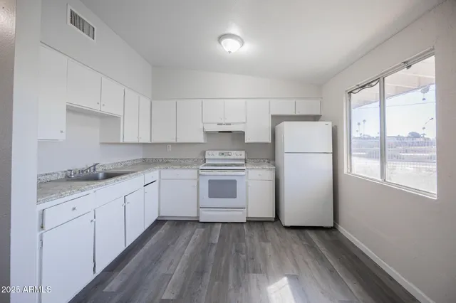 a kitchen with a white cabinets and white appliances