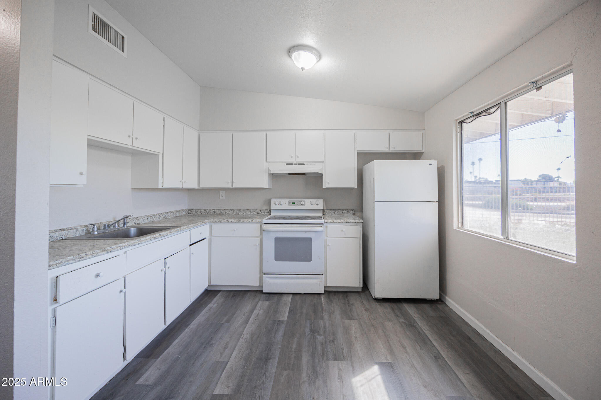 2123 West Devonshire Avenue, Unit 14 Phoenix, AZ 85015 - Photo 7 of 13 a kitchen with a white cabinets and white appliances