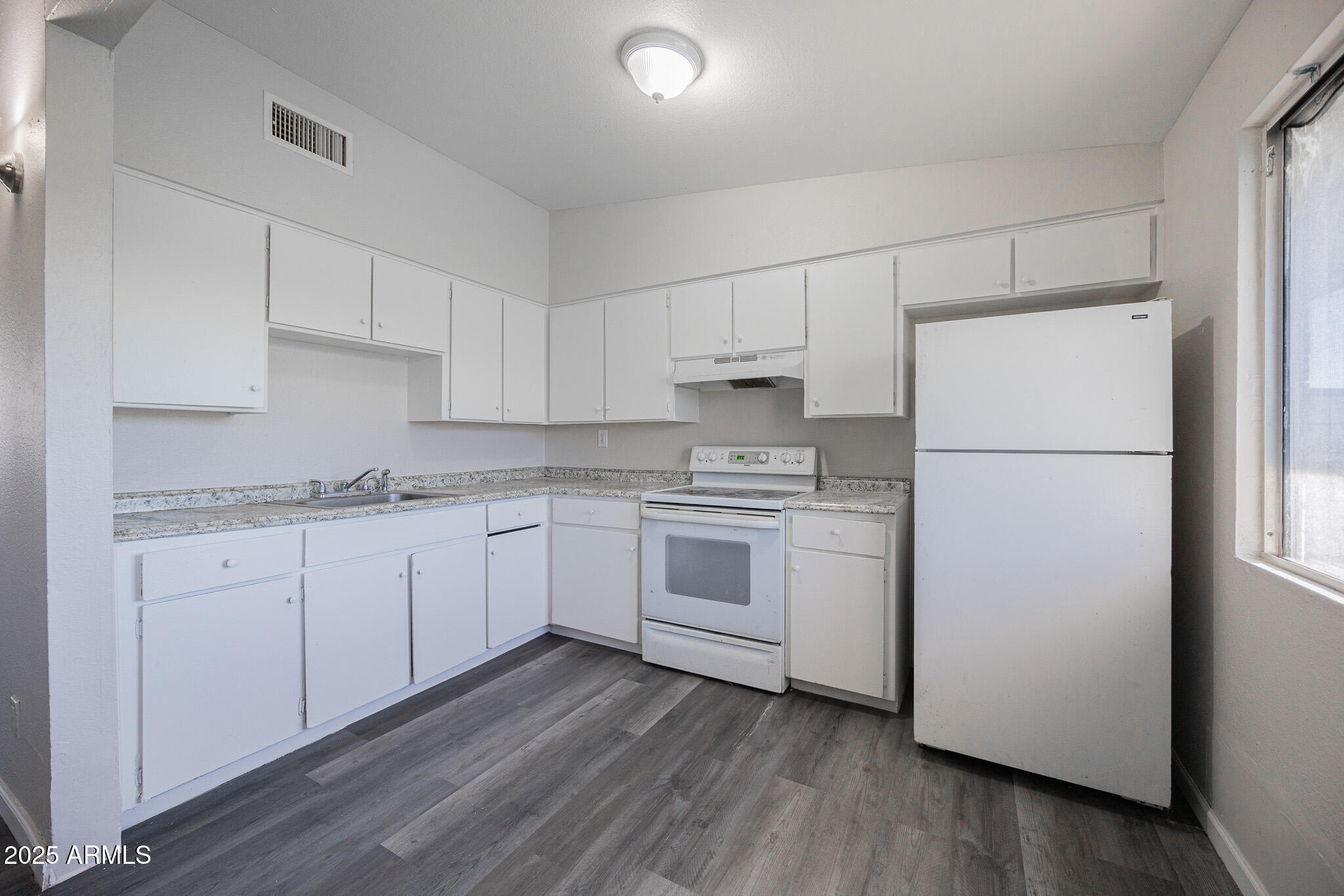 2123 West Devonshire Avenue, Unit 14 Phoenix, AZ 85015 - Photo 8 of 13 a kitchen with white cabinets and white appliances